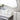 White towels with elegant beige stripes, neatly stacked and hung in a refined bathroom setting.