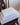 Stack of white linen fibre bath towels with a textured weave, neatly placed on a wooden chair, showcasing their natural elegance, durability, and quick-drying properties.