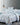 Micromodal floral duvet cover and pillowcases in blue and white tones on a cozy bed with layered blankets, styled in a modern bedroom.