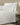 White Egyptian Cotton Sateen bedding set with pillows, beside a modern nightstand and lamp.