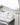 White towels with elegant beige stripes, neatly stacked and hung in a refined bathroom setting.