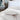 Close-up of a plush white duvet and pillow on a neatly made bed, showcasing soft, high-quality bedding in a classic and elegant bedroom setting.