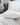 Close-up of a plush white duvet and pillow on a neatly made bed, showcasing soft, high-quality bedding in a classic and elegant bedroom setting.